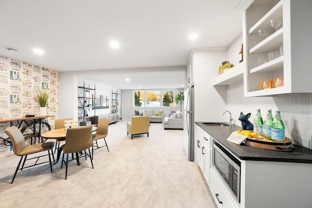 dining room with light carpet and recessed lighting