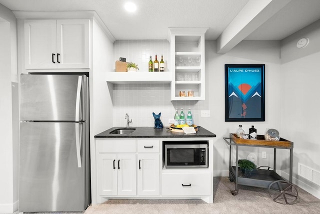 interior space featuring white cabinets, appliances with stainless steel finishes, open shelves, backsplash, and light colored carpet