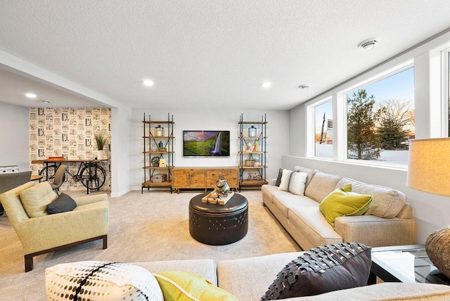 living area with carpet floors, a textured ceiling, and visible vents