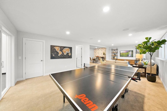recreation room featuring baseboards, light colored carpet, and recessed lighting
