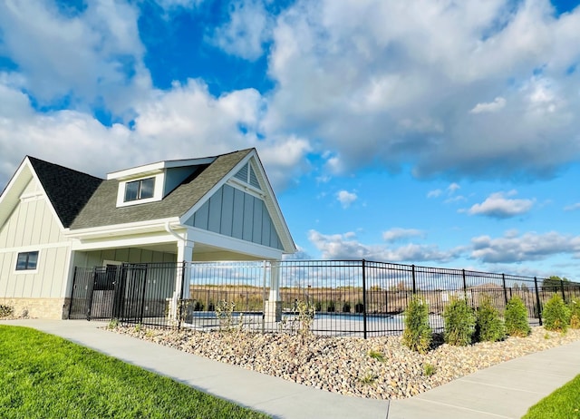 view of property's community featuring an attached carport and a fenced front yard