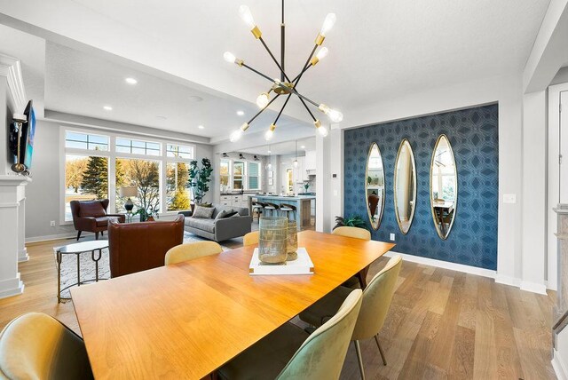 2712 Kensington Ave NE, Saint Michael, MN 55376 - dining area with light wood finished floors, baseboards, a chandelier, recessed lighting, and wallpapered walls