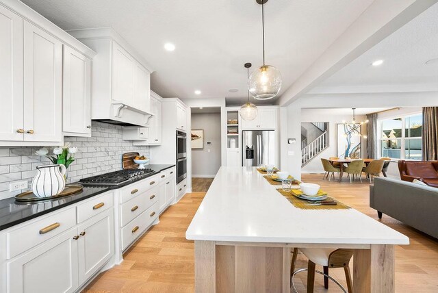 2712 Kensington Ave NE, Saint Michael, MN 55376 - kitchen with appliances with stainless steel finishes, backsplash, a kitchen island, recessed lighting, and white cabinets