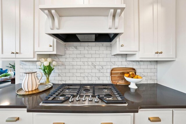 2712 Kensington Ave NE, Saint Michael, MN 55376 - kitchen with custom range hood, dark countertops, white cabinets, and stainless steel gas stovetop