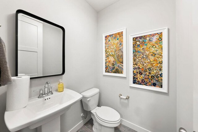 2712 Kensington Ave NE, Saint Michael, MN 55376 - half bath featuring baseboards, toilet, and a sink