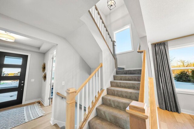 2712 Kensington Ave NE, Saint Michael, MN 55376 - entrance foyer featuring wood finished floors, stairway, and baseboards