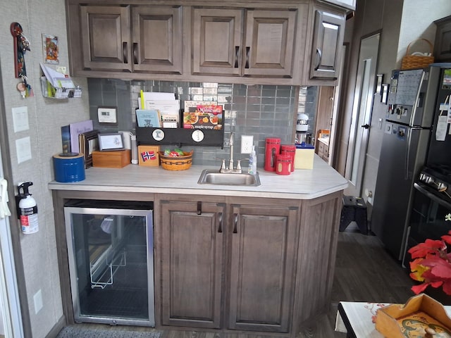 2945 County Road 4 SW Unit 69, Cokato, MN 55321 - kitchen featuring wine cooler, light countertops, a sink, backsplash, and freestanding refrigerator