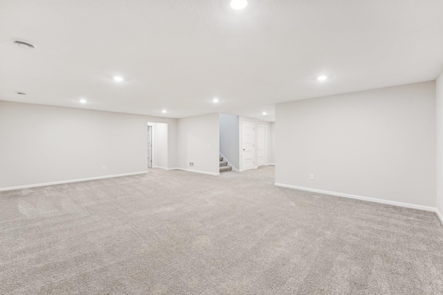finished basement featuring stairs, baseboards, and recessed lighting