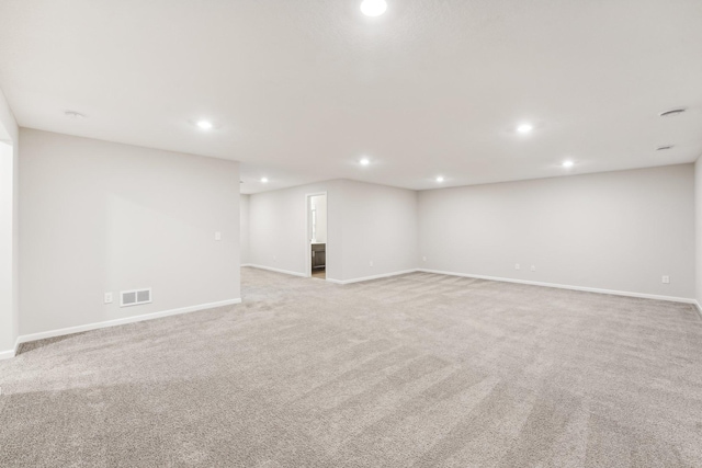 finished basement with recessed lighting, light carpet, baseboards, and visible vents