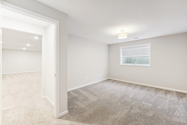 unfurnished room featuring baseboards and carpet