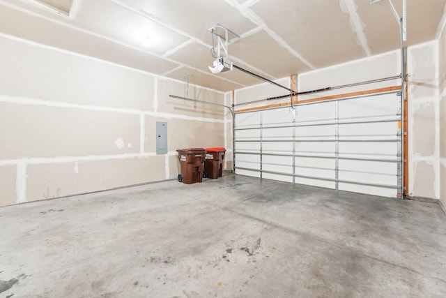 garage with a garage door opener and electric panel