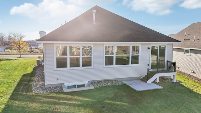 rear view of property featuring a lawn and central AC