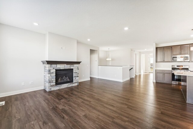 238 Jade Trl N, Lake Elmo, MN 55042 - unfurnished living room with dark wood finished floors, recessed lighting, baseboards, and a stone fireplace