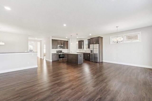 238 Jade Trl N, Lake Elmo, MN 55042 - unfurnished living room featuring a chandelier, dark wood-style flooring, recessed lighting, and baseboards