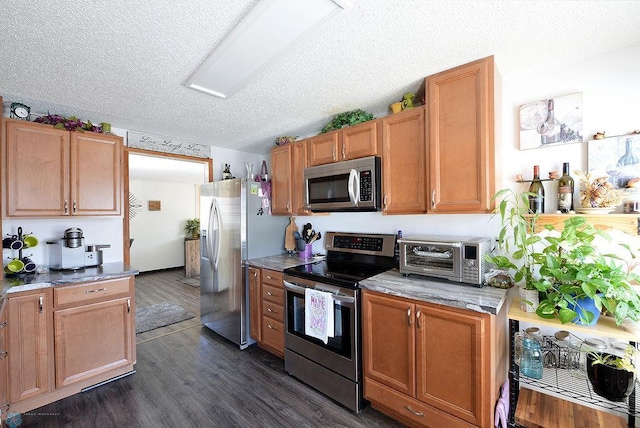 318 Morrison St, West Fargo, ND 58078 - kitchen with dark wood-style flooring, a toaster, a textured ceiling, brown cabinetry, and stainless steel appliances