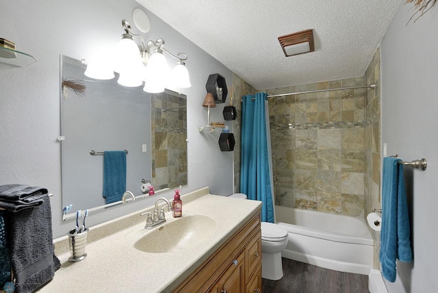 318 Morrison St, West Fargo, ND 58078 - bathroom with a textured ceiling, vanity, toilet, wood finished floors, and shower / tub combo with curtain
