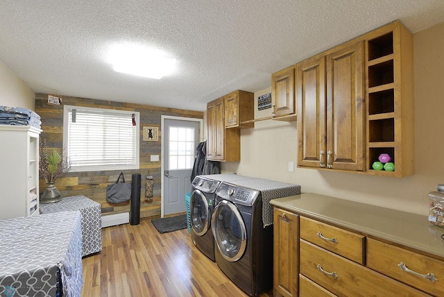 318 Morrison St, West Fargo, ND 58078 - laundry area with a textured ceiling, light wood finished floors, cabinet space, and washer and clothes dryer