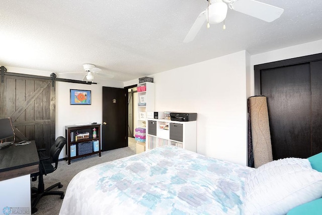 318 Morrison St, West Fargo, ND 58078 - bedroom featuring light carpet, ceiling fan, a barn door, and a textured ceiling