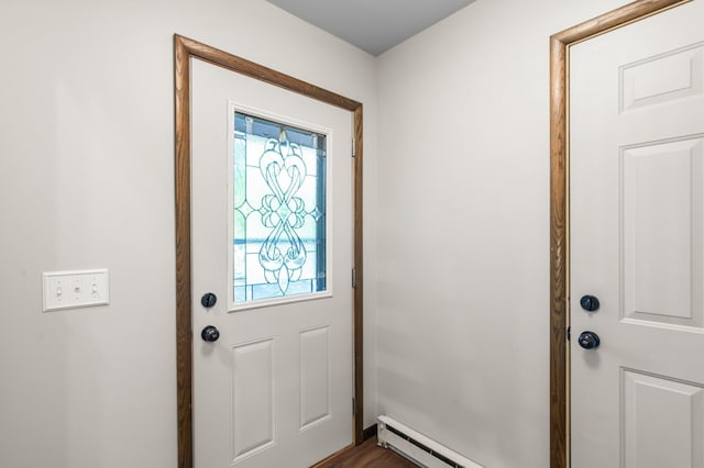 doorway to outside with a baseboard heating unit