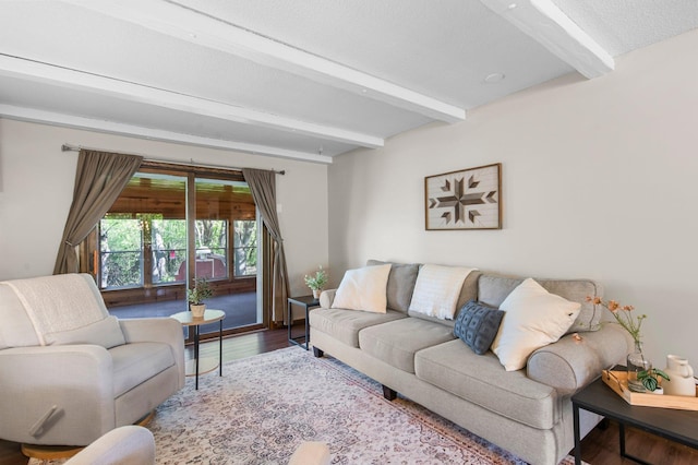 living room featuring beamed ceiling and wood finished floors