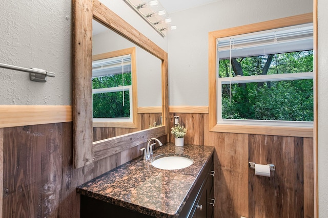 bathroom with vanity and a textured wall