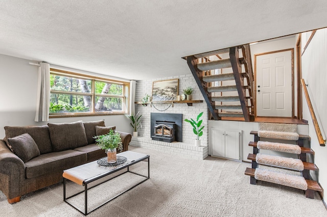 living room with stairs, carpet flooring, and a textured ceiling