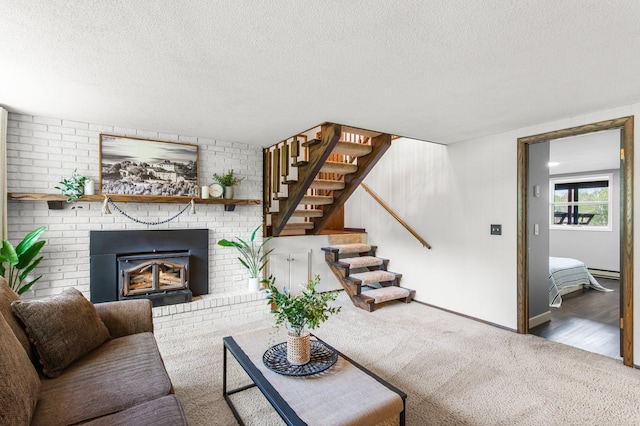 carpeted living area with a textured ceiling, stairway, a baseboard heating unit, and baseboards
