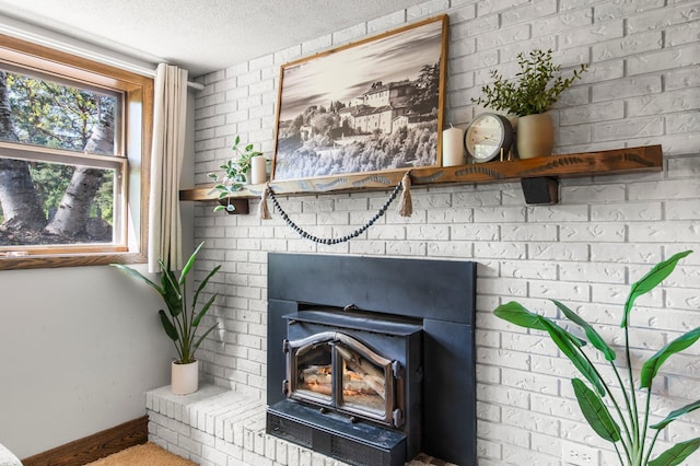 detailed view of baseboards, a textured ceiling, and a wood stove