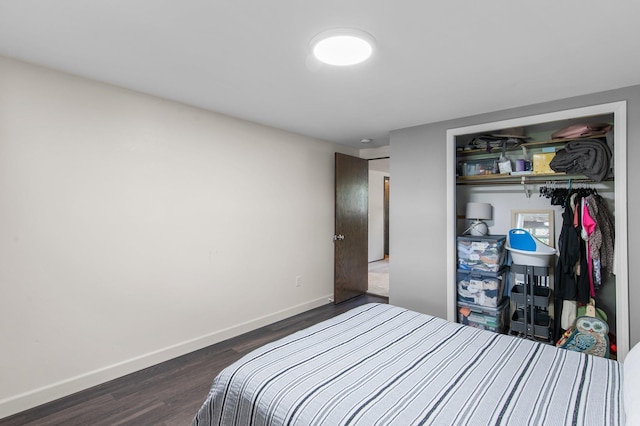 bedroom featuring a closet, baseboards, and dark wood-style floors
