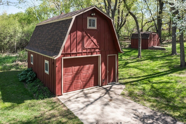 detached garage with concrete driveway and a shed