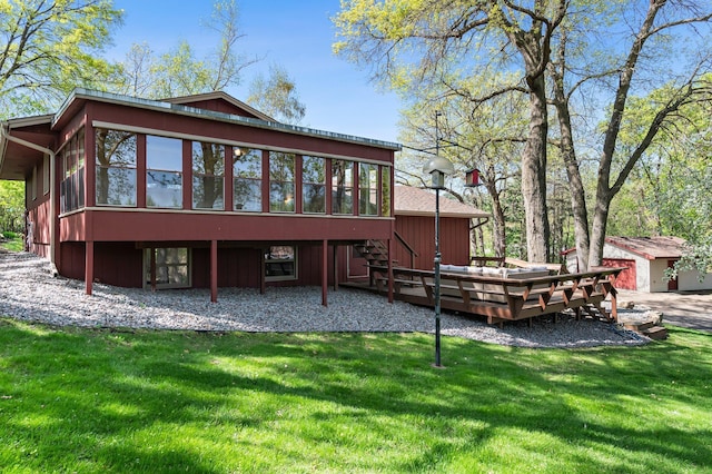 back of house with a sunroom, a wooden deck, stairway, and a yard