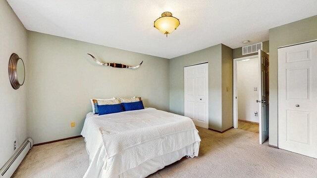 450 Ford Rd Unit 217, Saint Louis Park, MN 55426 - bedroom featuring a baseboard radiator, light carpet, and a closet
