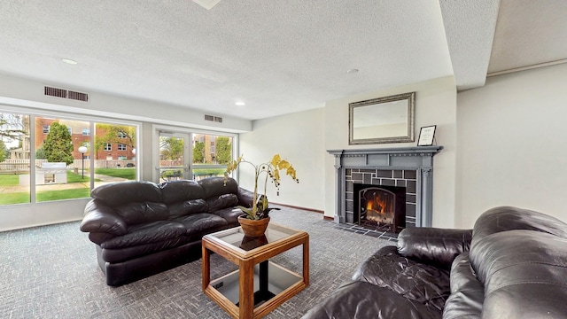 450 Ford Rd Unit 217, Saint Louis Park, MN 55426 - carpeted living room featuring a textured ceiling, a tiled fireplace, and recessed lighting
