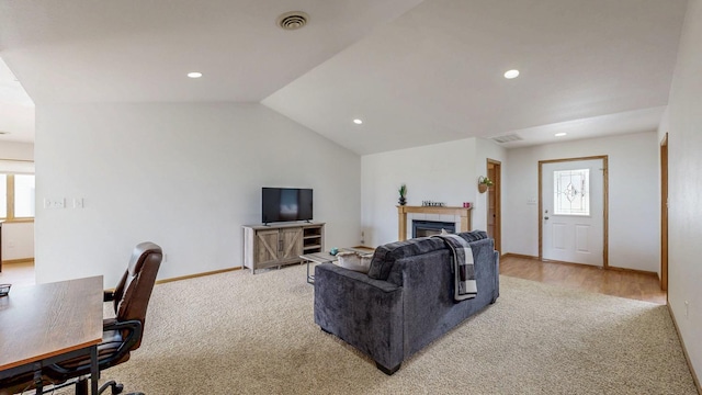 930 5th Ave, Goodhue, MN 55027 - living area with a tile fireplace, visible vents, light colored carpet, and lofted ceiling