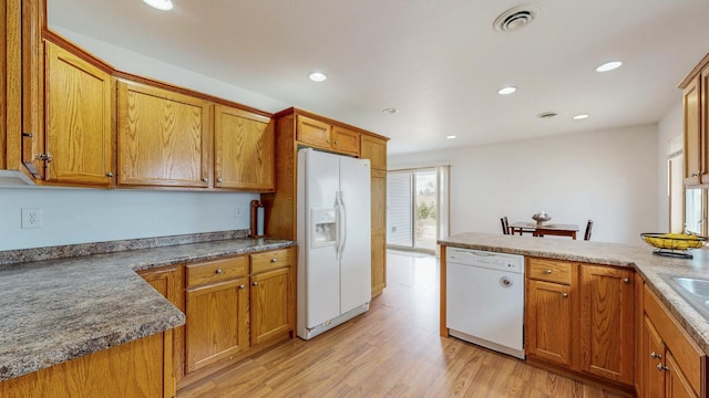 930 5th Ave, Goodhue, MN 55027 - kitchen with white appliances, brown cabinetry, and light wood finished floors