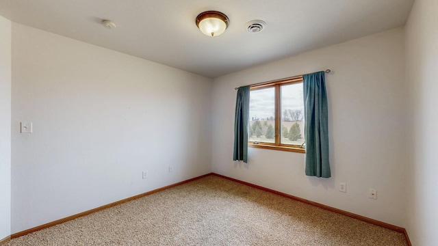 930 5th Ave, Goodhue, MN 55027 - spare room with visible vents, light colored carpet, and baseboards