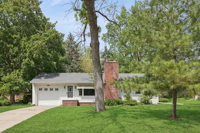 611 7th St E, Northfield, MN 55057 - view of front of property with a chimney, a garage, a front lawn, concrete driveway, and roof with shingles