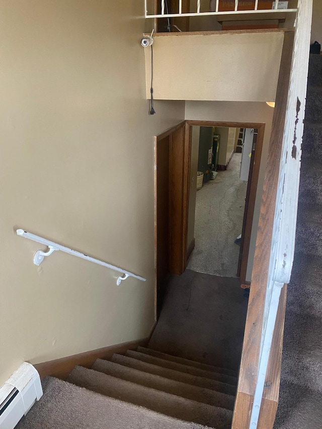 stairway with carpet flooring and a baseboard radiator