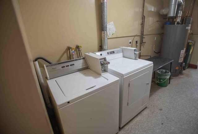 laundry room featuring washer and dryer, water heater, light colored carpet, and laundry area