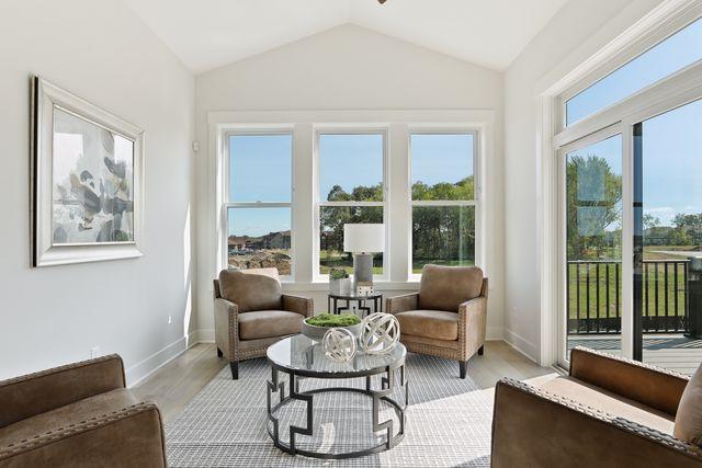 4036 Arbor Dr, Woodbury, MN 55129 - sitting room with lofted ceiling, light wood-style flooring, and baseboards