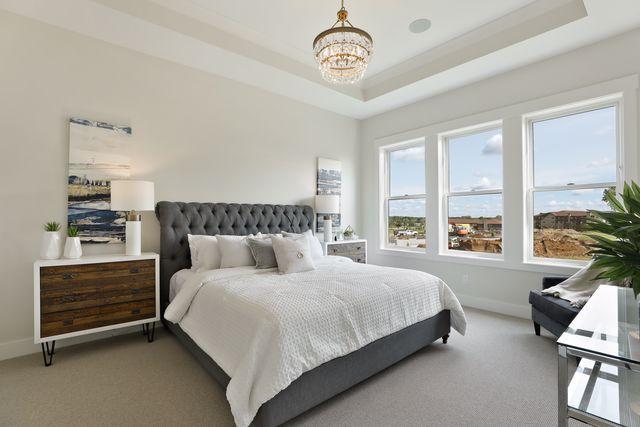 4036 Arbor Dr, Woodbury, MN 55129 - bedroom with a chandelier, baseboards, light colored carpet, and a raised ceiling