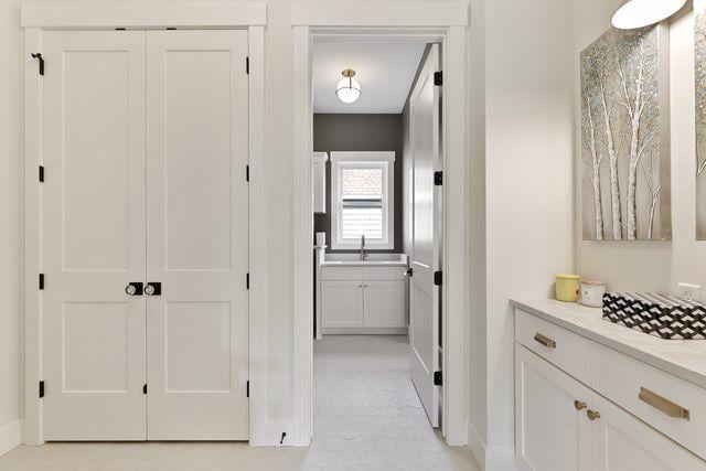 4036 Arbor Dr, Woodbury, MN 55129 - corridor with light tile patterned floors and baseboards