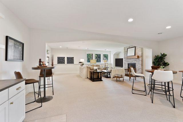 4036 Arbor Dr, Woodbury, MN 55129 - living room with a fireplace, light carpet, recessed lighting, and baseboards