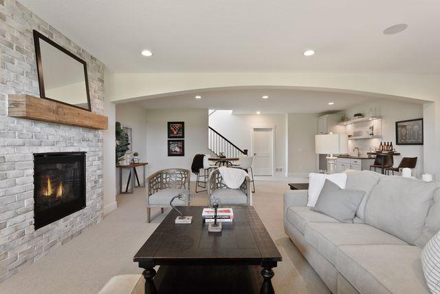 4036 Arbor Dr, Woodbury, MN 55129 - living area featuring stairway, recessed lighting, a large fireplace, light colored carpet, and baseboards