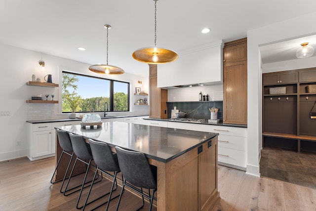 kitchen with recessed lighting, open shelves, backsplash, and dark countertops