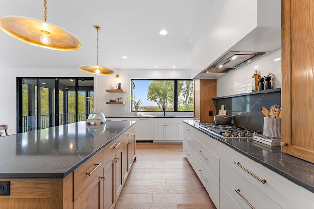 kitchen with open shelves, decorative backsplash, recessed lighting, ventilation hood, and light wood finished floors