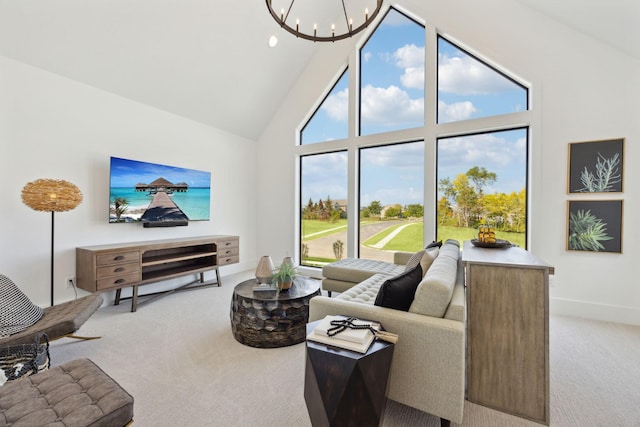 carpeted living area with baseboards, a chandelier, and high vaulted ceiling