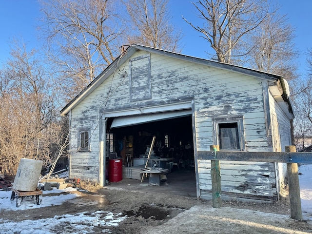 snow covered garage featuring a garage