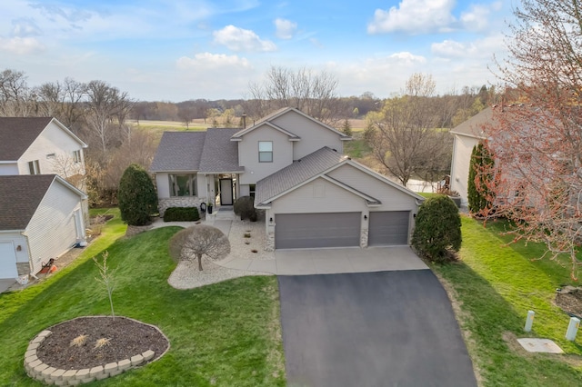traditional-style home with an attached garage, aphalt driveway, stone siding, and a front yard