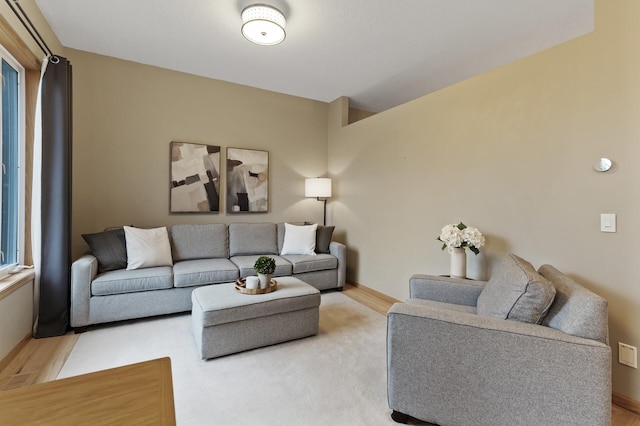living room featuring baseboards and light wood-style flooring